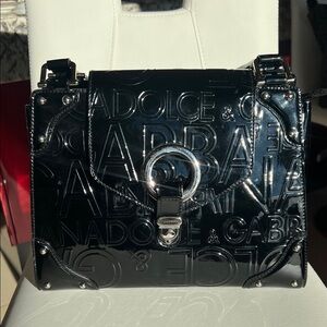 vintage Dolce & Gabbana black patent top-handle handbag from “logo mania” era